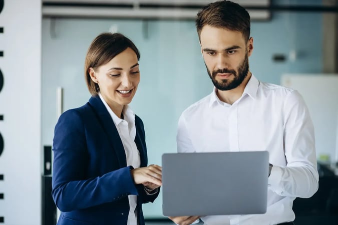 colleagues talking at a laptop
